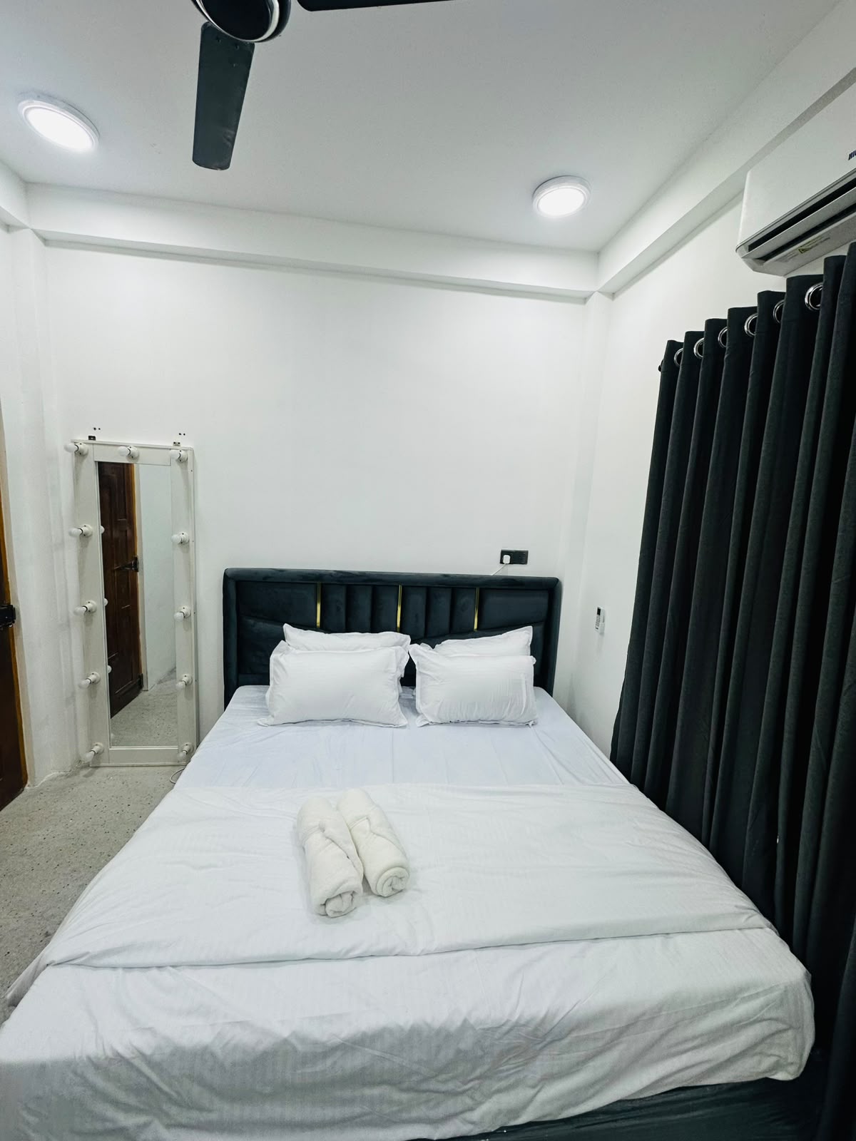 Air-conditioned bedroom with dark curtains at Citadine Green