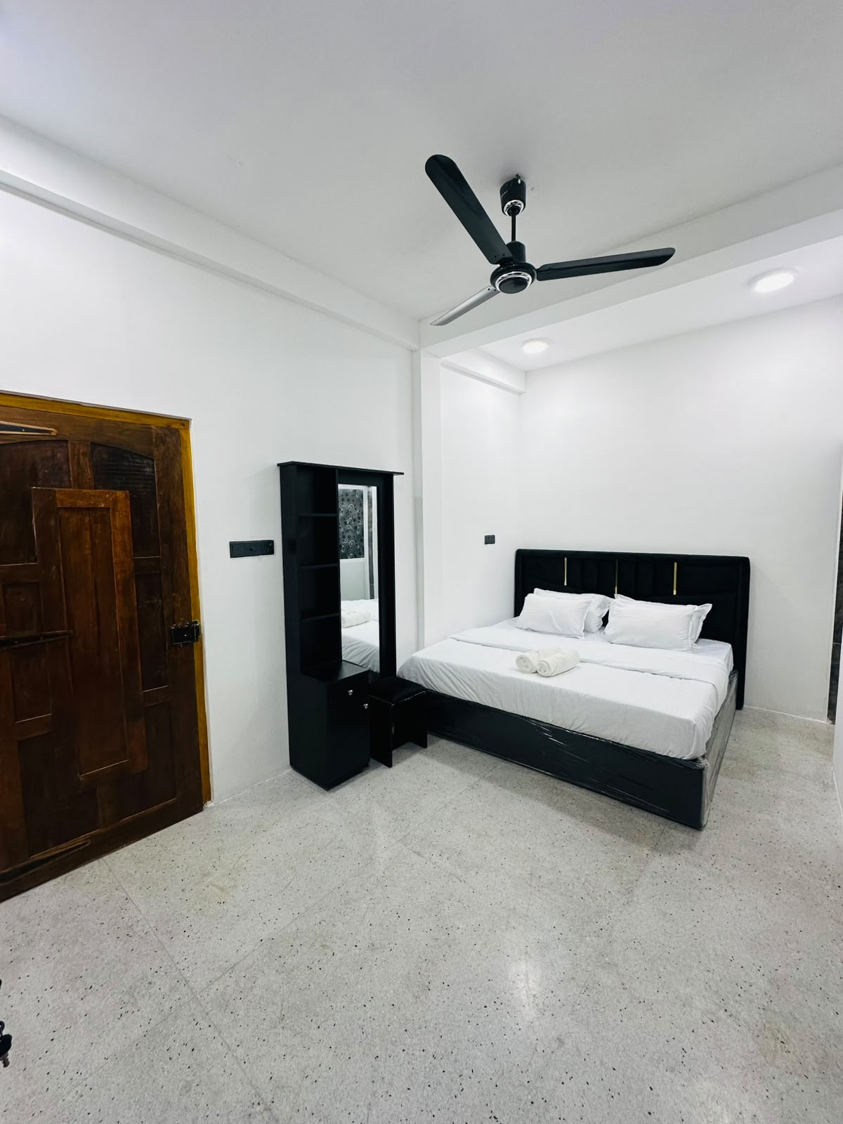 Bedroom with dark curtains and clear floor area near the bed